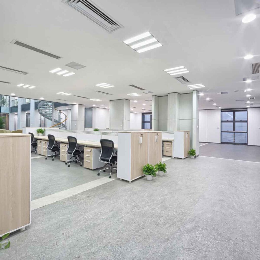 A modern office lit by overhead LED lights